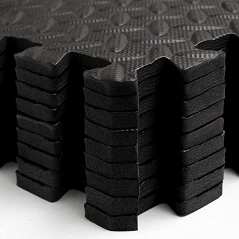 Laad afbeelding in Galerijviewer, Close-up van zwarte, gestructureerde antislip akoestische puzzelmatten, netjes gestapeld.
