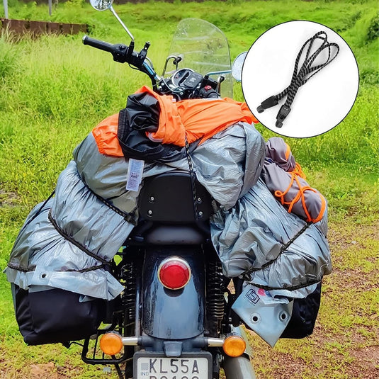 Een motorfiets zwaar beladen met bagage, vastgezet met Snelbinders voor veiligheid en gemak in één tegen een groene natuurlijke achtergrond.