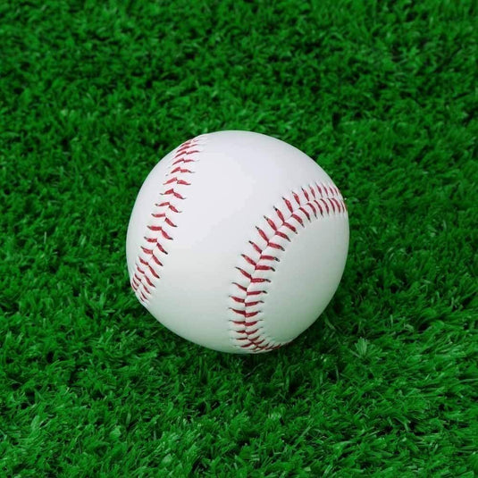 Een Perfecte PVC honkbal trainingsbal met rode stiksels op levendig groen kunstgras.