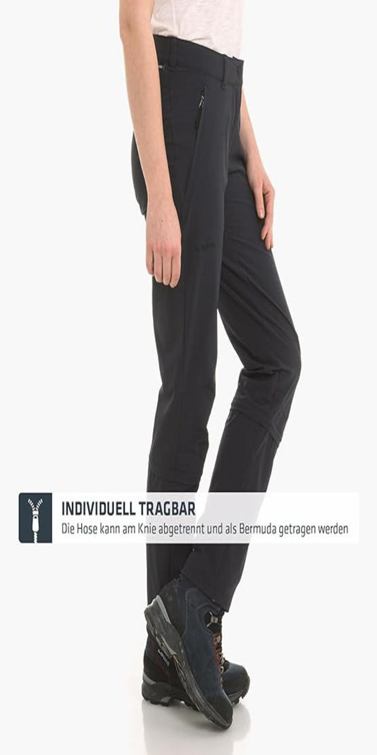 Ontdek de perfecte wandelbroek voor dames - Zwart toont een zwarte converteerbare broek met 4-way stretch die kan worden omgevormd tot een korte broek, gecombineerd met wandelschoenen.