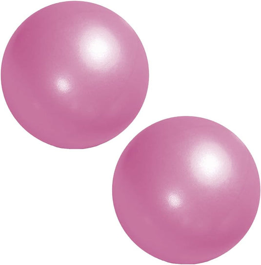 Twee glimmende roze bollen als Pilatesballen, met reflecterende oppervlakken op een effen witte achtergrond. Product: Versterk je core en verbeter je balans met onze pilatesbal!.