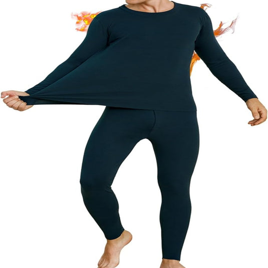 Een persoon draagt een donkerblauwe Warm blijven en comfortabel bewegen in de winter met thermo ondergoed voor heren set met hoge elasticiteit, staat op één voet met armen uitgestrekt.