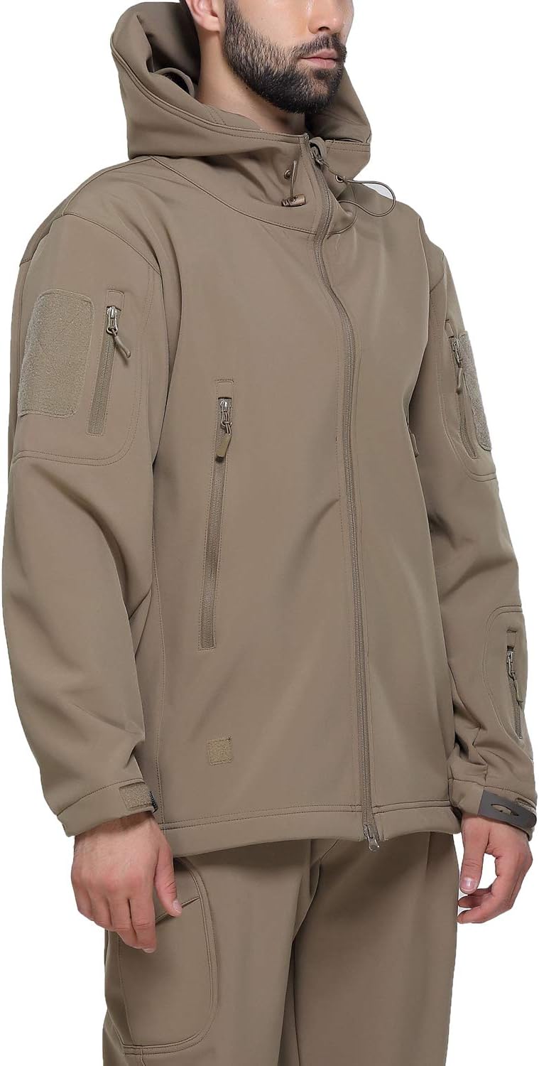 Load image into Gallery viewer, Man in een camouflage tactische heren softshell jas met meerdere zakken met ritssluiting en klittenbandpatches, staande met handen gedeeltelijk in broekzakken.
